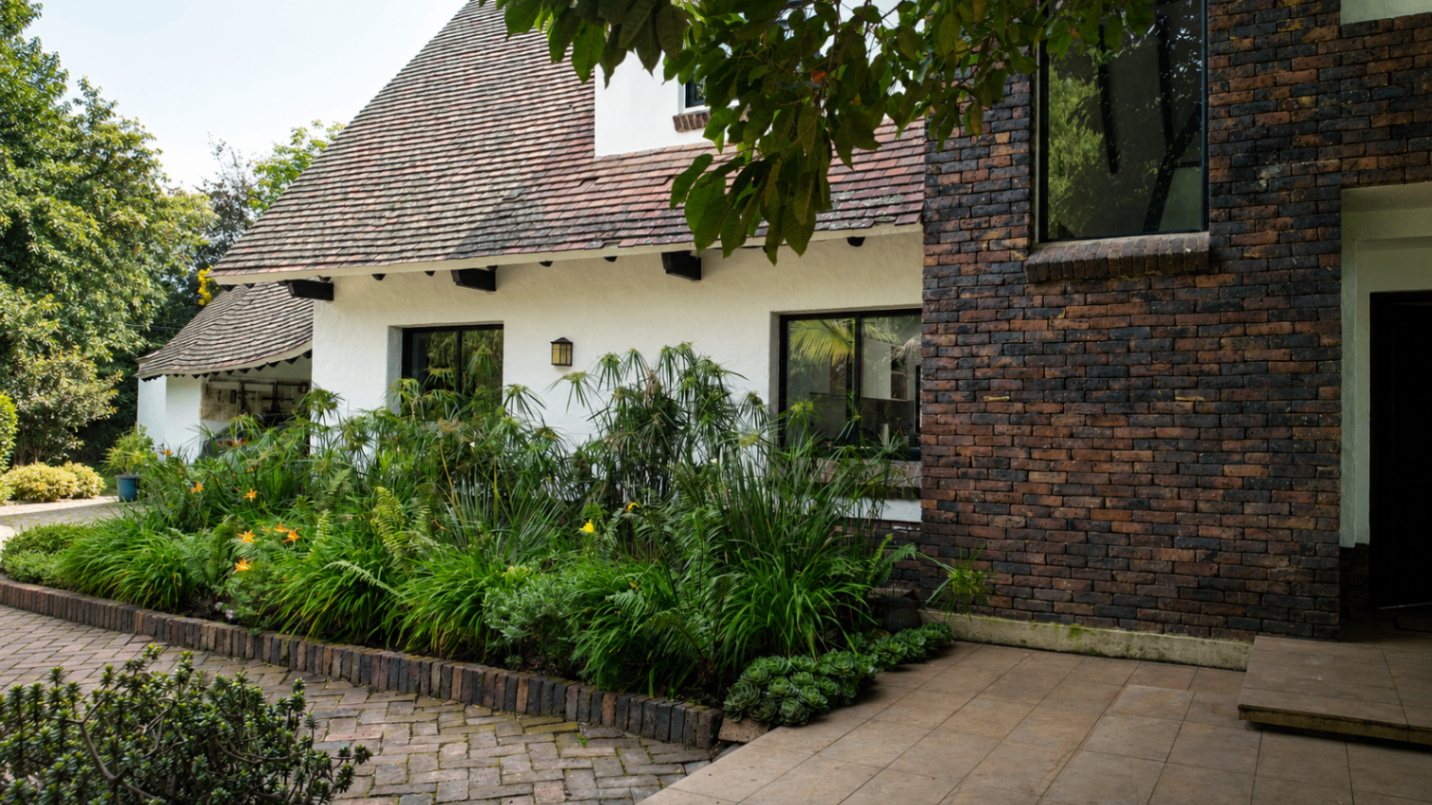 Fachada lateral con jardines